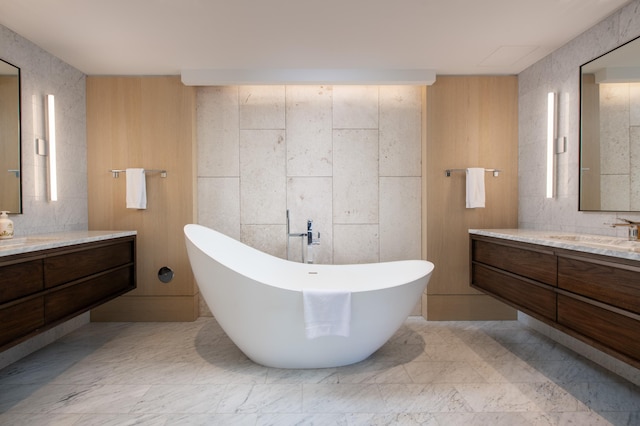 bathroom with a tub and vanity