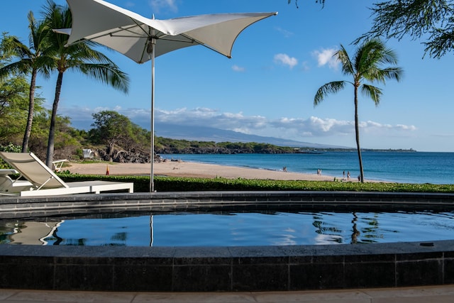 view of pool featuring a water view