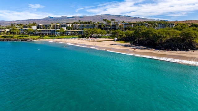 view of pool featuring a water and mountain view and a beach view