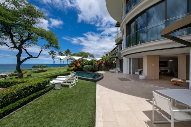 view of property's community featuring a patio area, a yard, a water view, and a pool