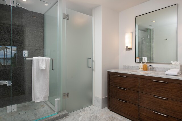 bathroom featuring vanity and a shower with door