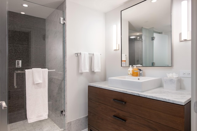 bathroom featuring vanity and a shower with door