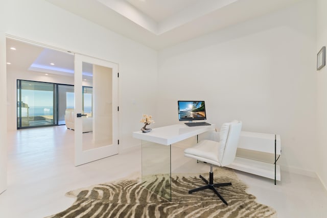 office space featuring a raised ceiling and french doors