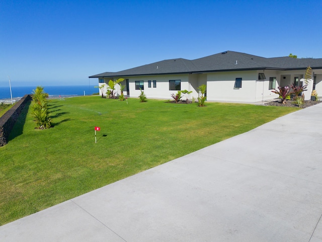 exterior space featuring a water view and a lawn