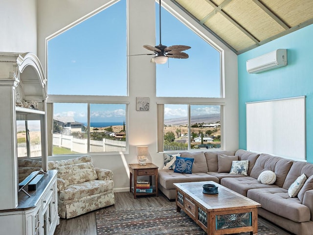 living room with dark hardwood / wood-style floors, high vaulted ceiling, a wall mounted AC, and a healthy amount of sunlight