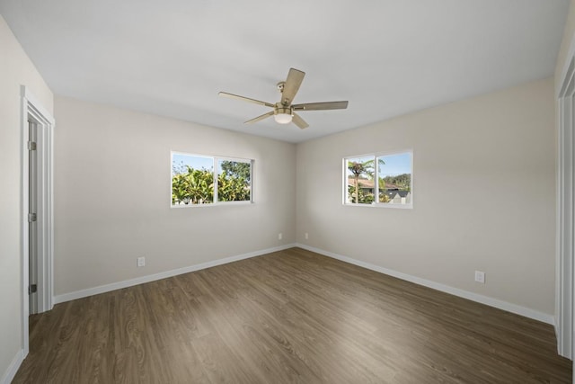 empty room featuring ceiling fan and dark hardwood / wood-style floors