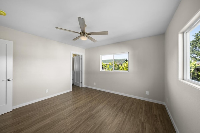 unfurnished room featuring ceiling fan, dark hardwood / wood-style flooring, and a healthy amount of sunlight