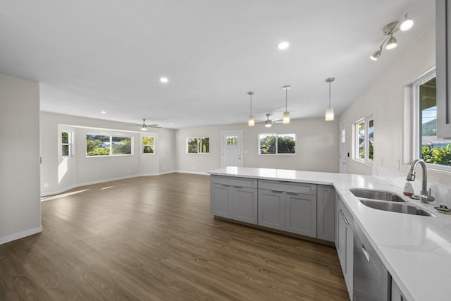 kitchen with pendant lighting, ceiling fan, sink, and a wealth of natural light