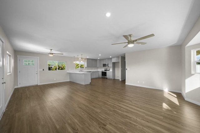 unfurnished living room with ceiling fan and dark hardwood / wood-style floors