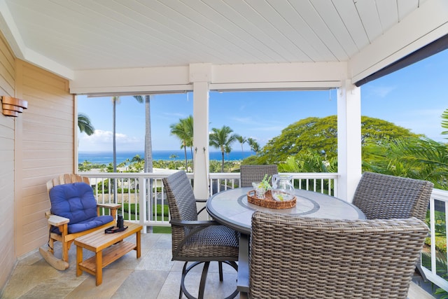 sunroom / solarium with wooden ceiling and a water view