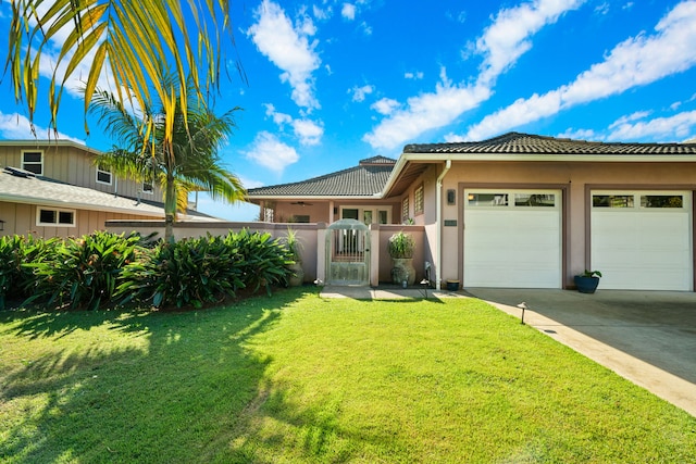 view of front facade with a garage and a front lawn