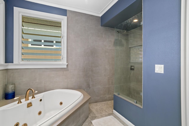 bathroom featuring tile patterned flooring, ornamental molding, tile walls, and independent shower and bath