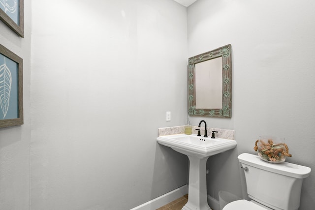 bathroom with tile patterned flooring and toilet