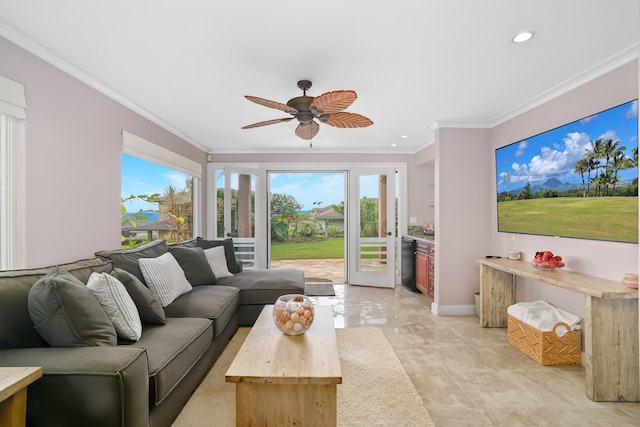 living room with ceiling fan, plenty of natural light, and ornamental molding