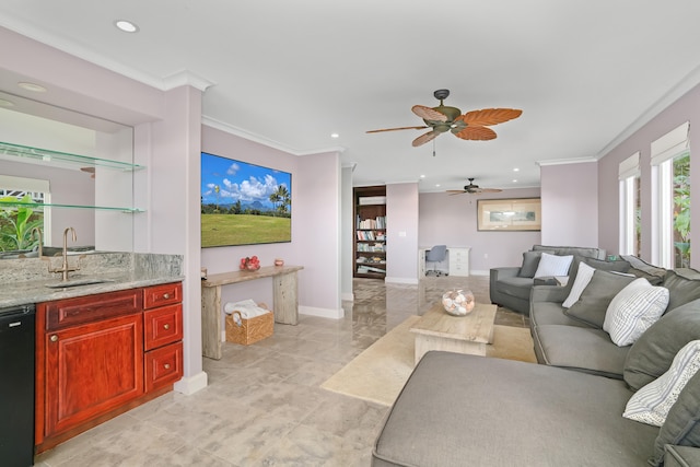 living room featuring crown molding, sink, and ceiling fan