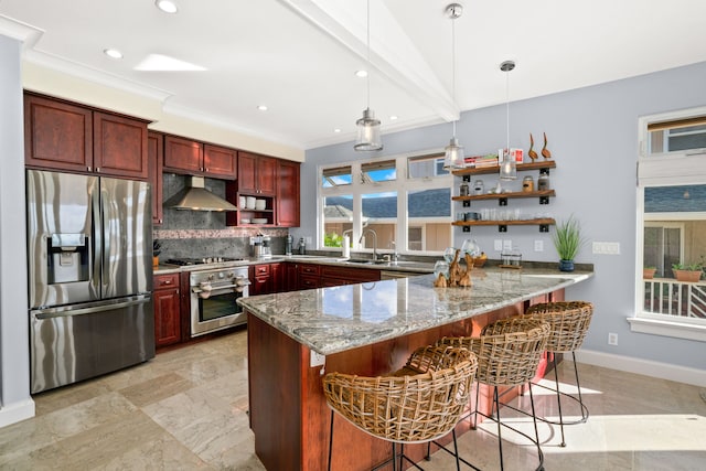 kitchen with light stone countertops, appliances with stainless steel finishes, a breakfast bar, ventilation hood, and pendant lighting