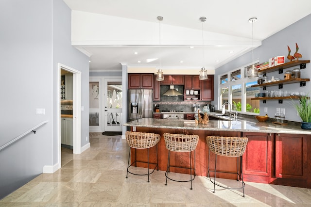 kitchen featuring a kitchen breakfast bar, hanging light fixtures, stainless steel appliances, and lofted ceiling