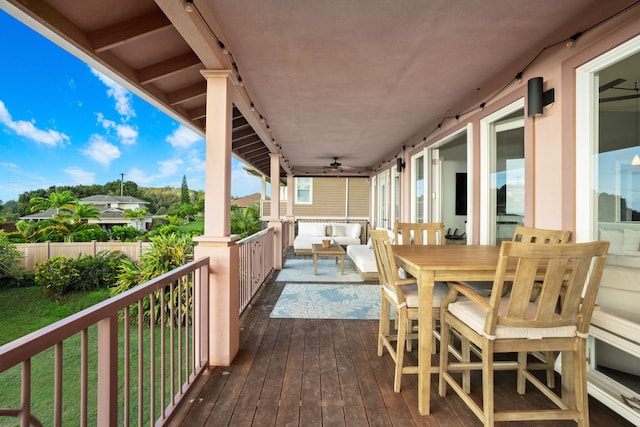 wooden terrace featuring outdoor lounge area and ceiling fan