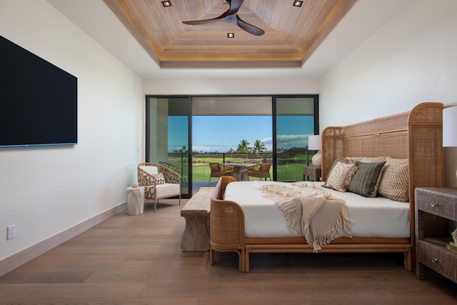 bedroom featuring ceiling fan, a raised ceiling, wood ceiling, and access to outside