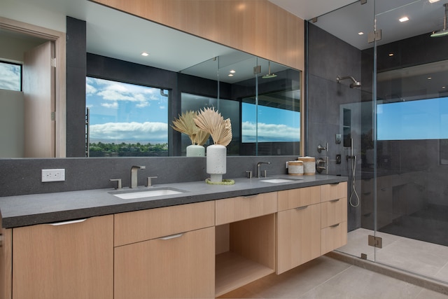 bathroom with decorative backsplash, vanity, tile patterned floors, and a shower with door