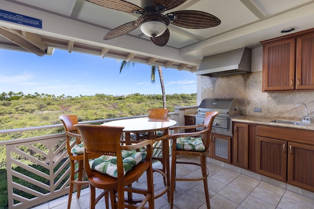 exterior space featuring area for grilling, ceiling fan, exterior kitchen, and sink