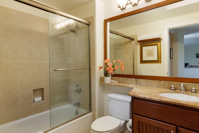 full bathroom with shower / bath combination with glass door, vanity, and toilet