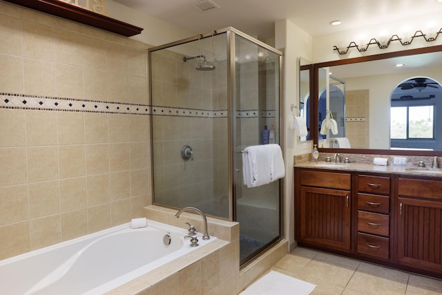 bathroom featuring tile patterned floors, vanity, and shower with separate bathtub