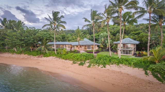 exterior space featuring a beach view and a water view