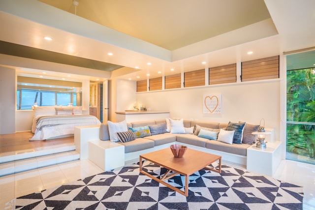 tiled living room with a tray ceiling