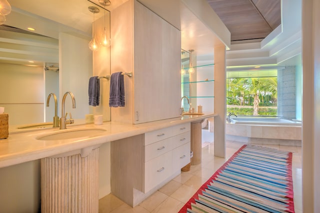 bathroom with tile patterned flooring, a tub to relax in, and sink