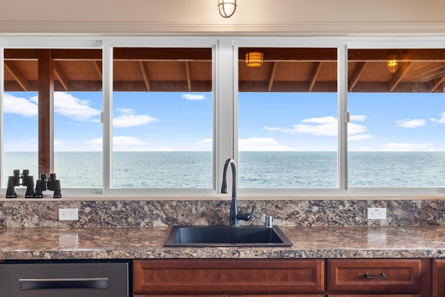 kitchen with plenty of natural light, a water view, and sink