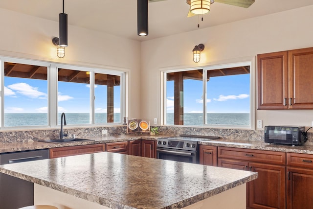 kitchen featuring a wealth of natural light, a water view, and stainless steel appliances