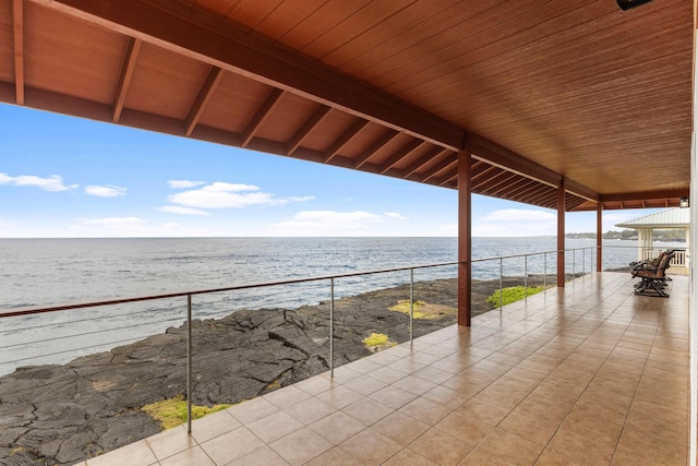 view of patio / terrace with a balcony and a water view