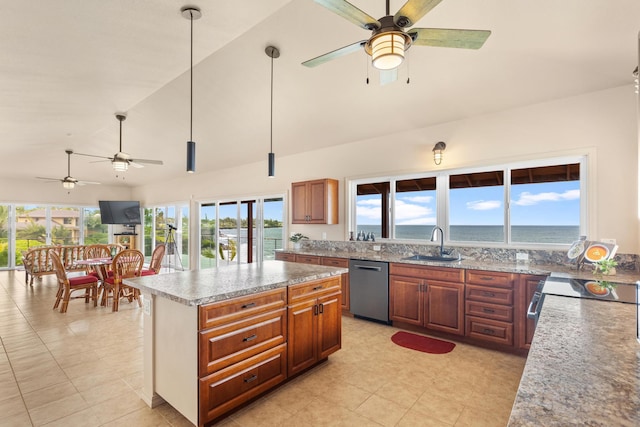 kitchen with a water view, sink, hanging light fixtures, stainless steel dishwasher, and a kitchen island