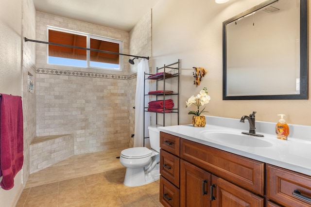 bathroom with tile patterned floors, vanity, toilet, and walk in shower