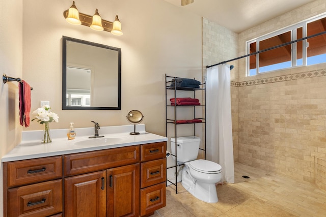 bathroom with a shower with curtain, a wealth of natural light, vanity, and toilet