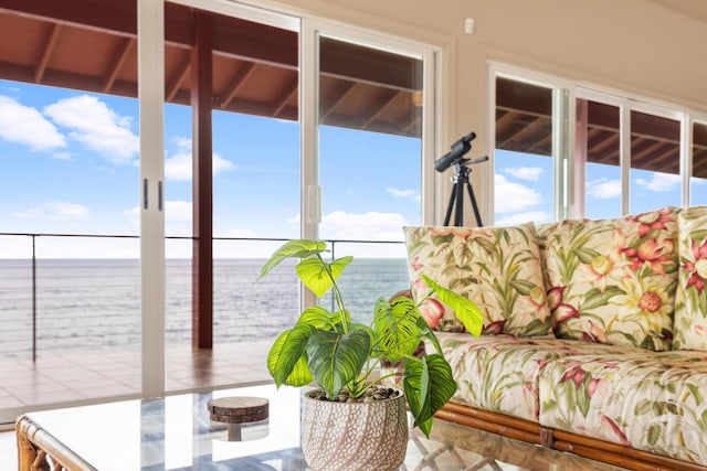 sunroom / solarium featuring a water view and a wealth of natural light