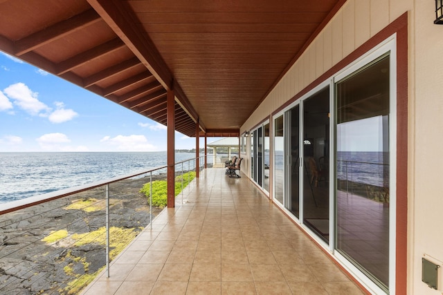 balcony featuring a water view and a beach view