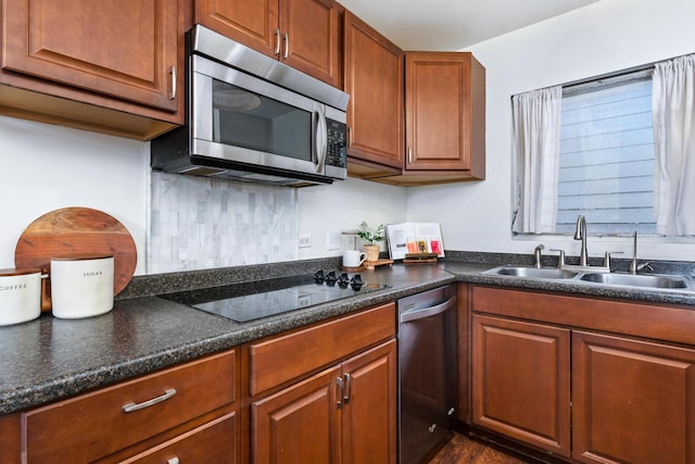 kitchen with decorative backsplash, sink, and appliances with stainless steel finishes