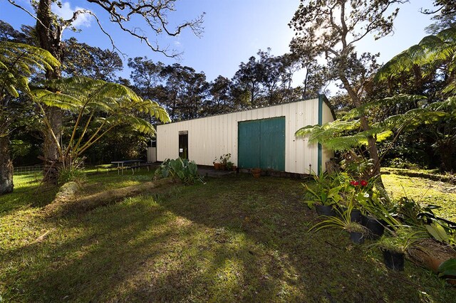 view of outdoor structure with a lawn