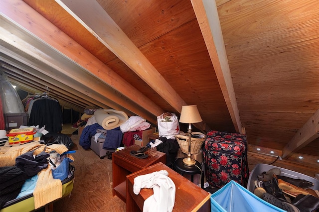 additional living space featuring vaulted ceiling with beams