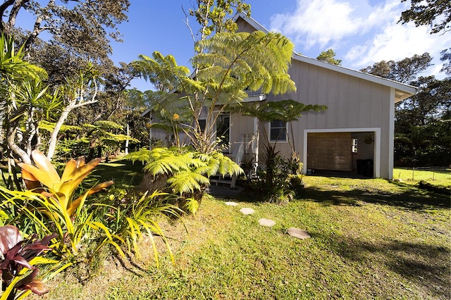 exterior space featuring a garage and a yard