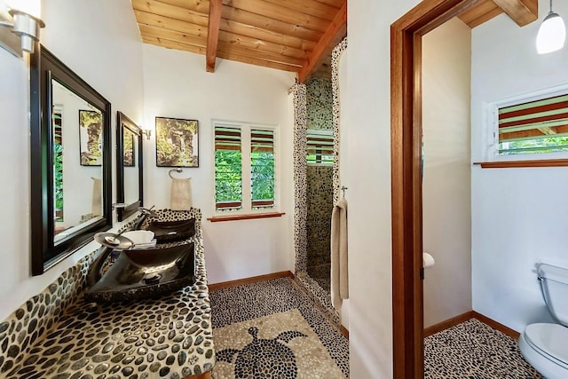 bathroom featuring toilet, wooden ceiling, and lofted ceiling with beams