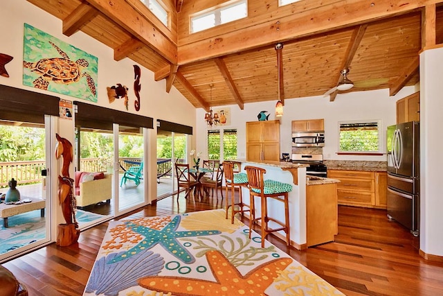 kitchen featuring stainless steel appliances, wooden ceiling, decorative light fixtures, high vaulted ceiling, and beam ceiling