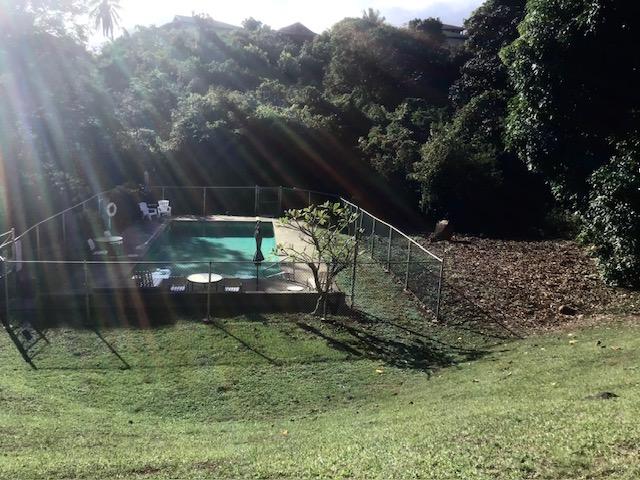 view of swimming pool with a yard