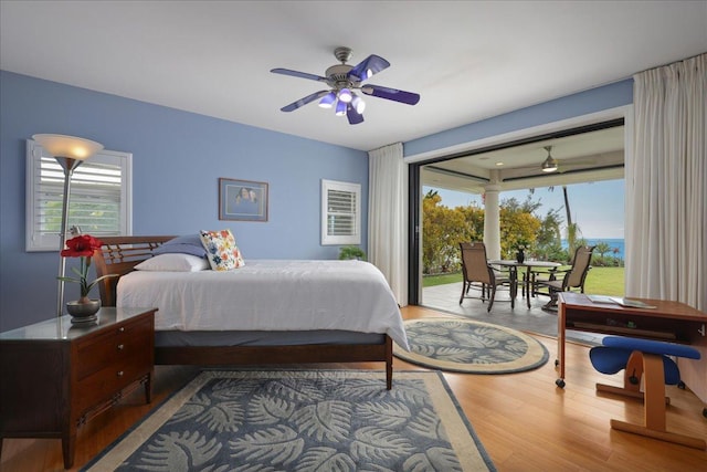 bedroom featuring ceiling fan, light hardwood / wood-style floors, and access to outside