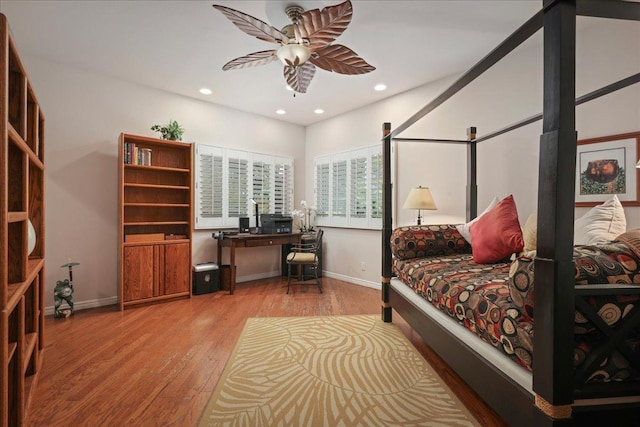 bedroom with ceiling fan and light hardwood / wood-style flooring