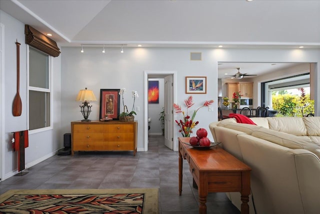 living room with ceiling fan, track lighting, and vaulted ceiling