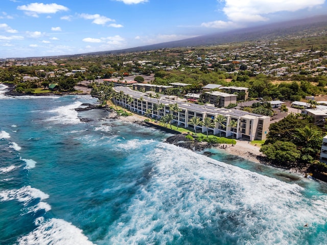 drone / aerial view with a water view and a view of the beach