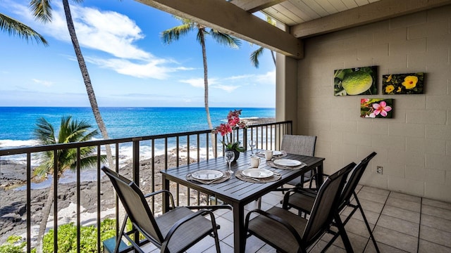 balcony featuring a water view and a view of the beach